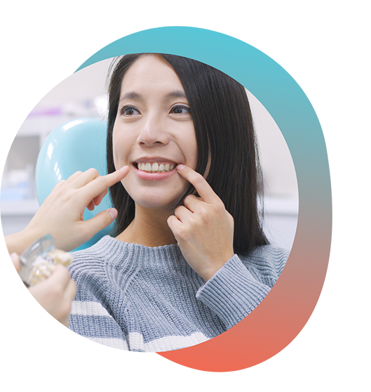 Female dental patient pointing to her smile