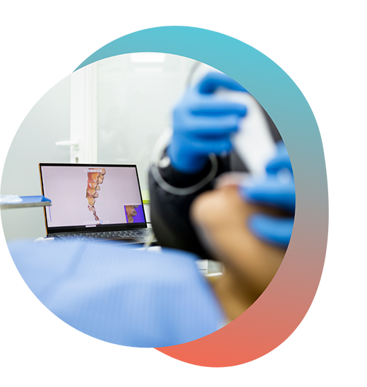 Monitor showing digital impression while dentist scans patients mouth