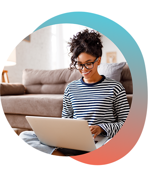 Woman in striped shirt typing on laptop