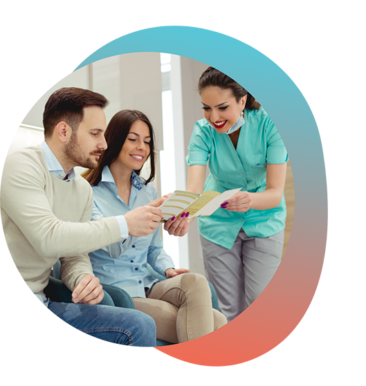 Man and woman looking at brochure from dentist