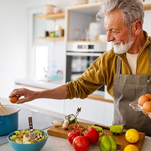 Person in Rowlett eating a healthy meal with dental implants