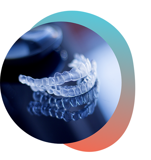 Two Invisalign clear aligners on a reflective surface