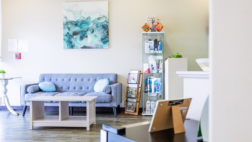 Blue couch and other objects in dental waiting room