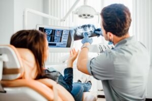 Dentist and patient looking at X-ray